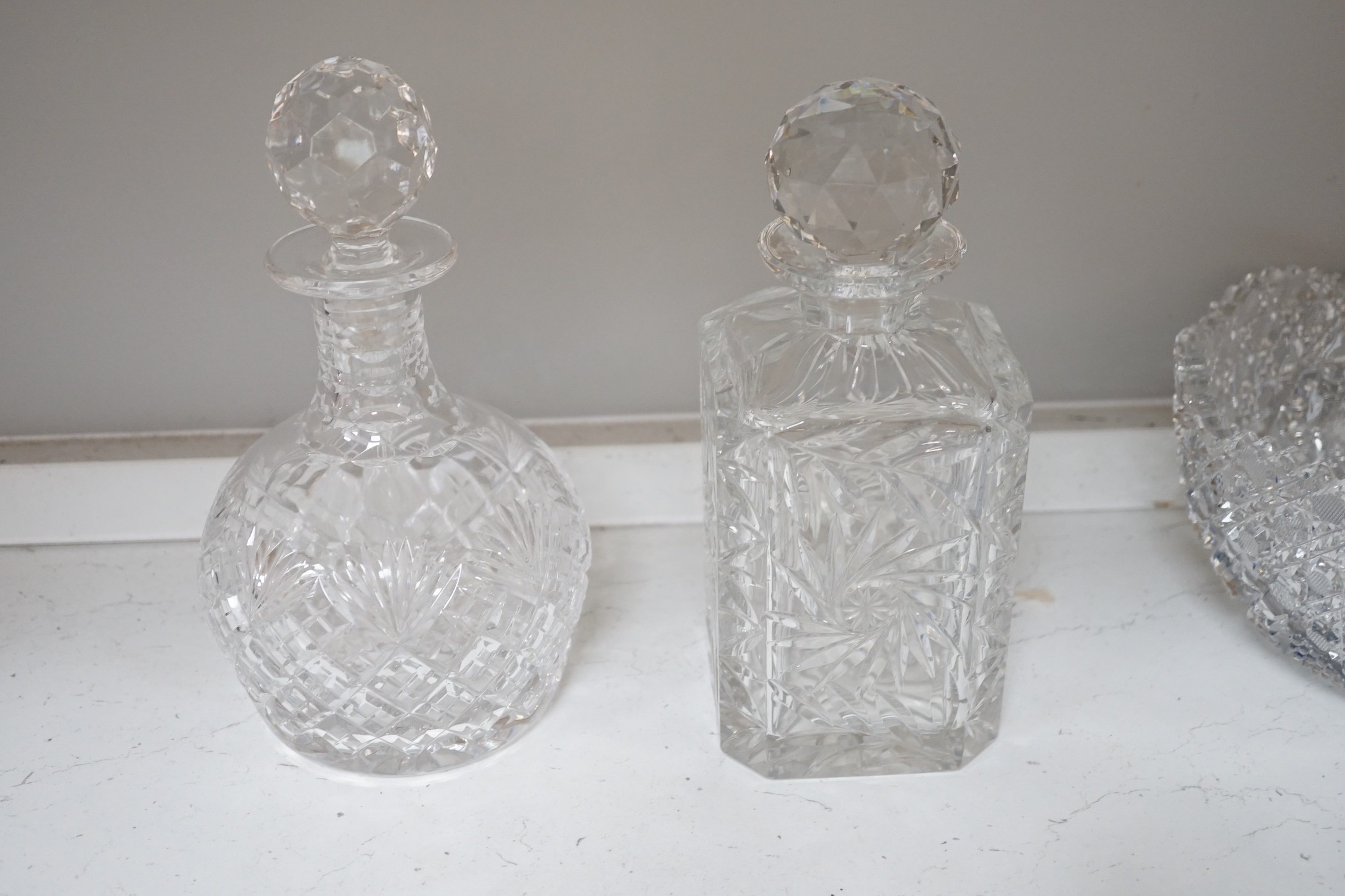 A Pair of Bohemian or Czech heavy cuts glass fruit bowls with blue flashed centres, 22.5 cm diameter, two decanters and six tumblers.